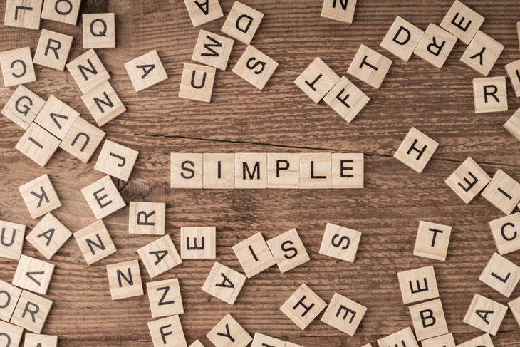 Letters in a Scrabble game, spelling the word "SIMPLE"